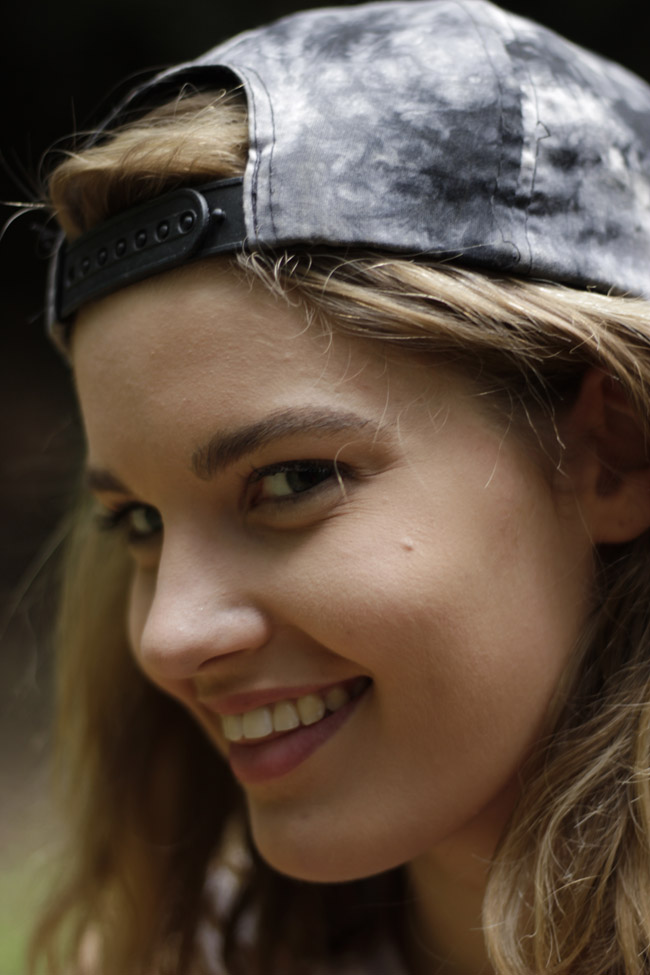 Close-up of girl wearing baseball hat